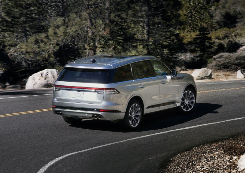 A 2023 Lincoln Aviator® Grand Touring model is shown being driven on a tight turn of a mountain road | Griffin Lincoln in Tifton GA