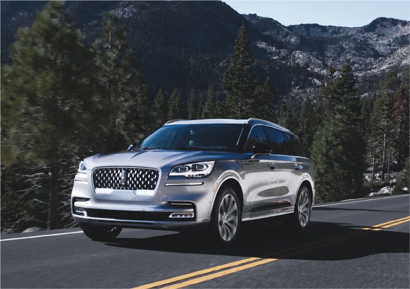 A 2023 Lincoln Aviator® Grand Touring SUV being driven on a winding road to demonstrate the capabilities of all-wheel drive | Griffin Lincoln in Tifton GA