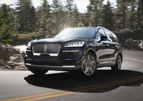 A Lincoln Aviator® SUV is being driven on a winding mountain road | Griffin Lincoln in Tifton GA