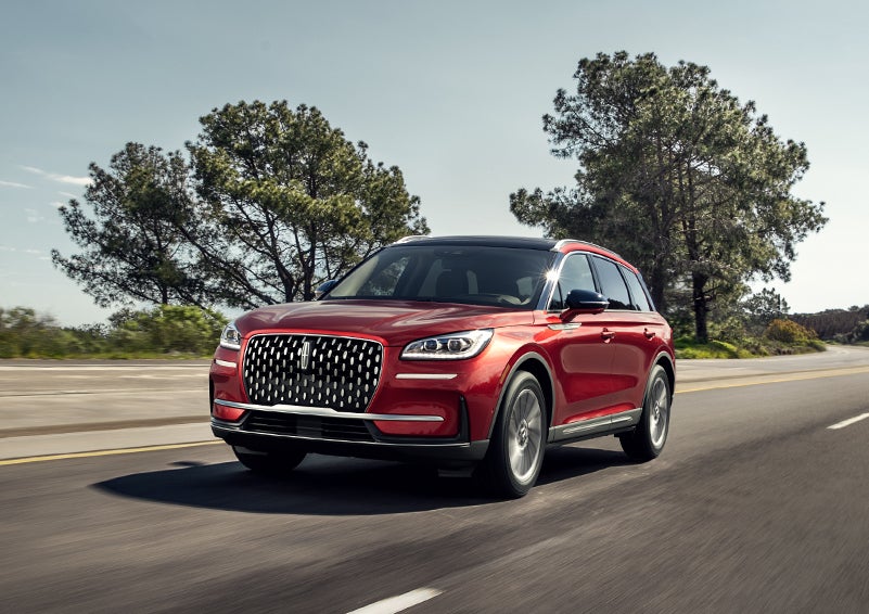 A 2024 Lincoln Corsair® SUV is shown being driven on a country road. | Griffin Lincoln in Tifton GA