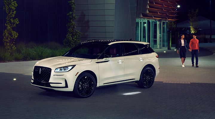 Two people approach a 2024 Lincoln Corsair® SUV featuring the available Jet Appearance Package. | Griffin Lincoln in Tifton GA