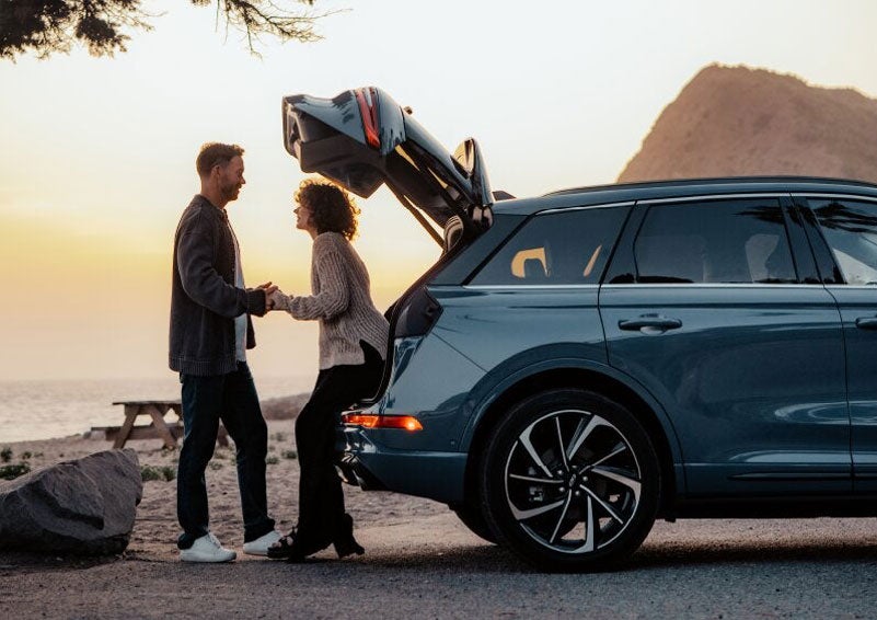 A couple share a moment together outside a 2025 Lincoln Corsair® SUV near the open liftgate. | Griffin Lincoln in Tifton GA