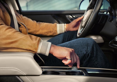 The driver of a 2024 Lincoln Corsair® SUV is shown selecting the drive mode. | Griffin Lincoln in Tifton GA