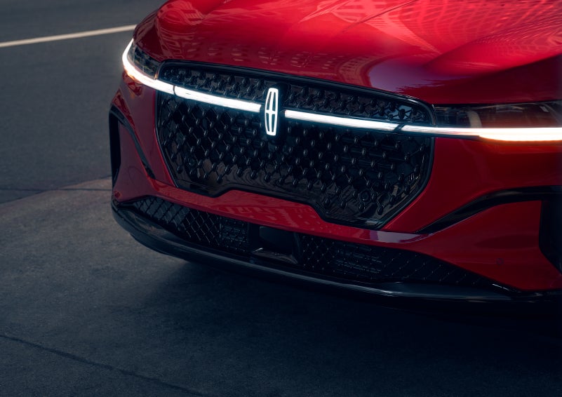 The available front LED light bar and center Lincoln Star logo glow at dusk. | Griffin Lincoln in Tifton GA