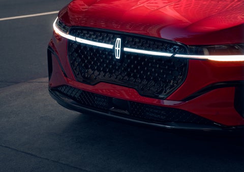 The available front LED light bar and center Lincoln Star logo glow at dusk. | Griffin Lincoln in Tifton GA