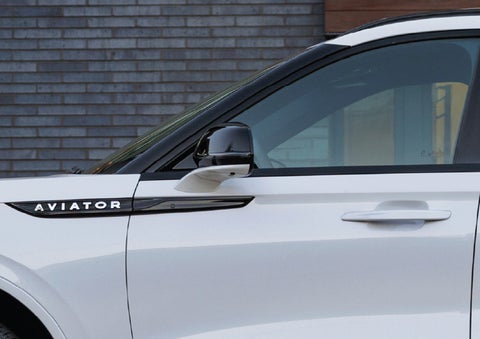 The driver’s side door and fender badging of a white 2026 Lincoln Aviator® SUV are showcased. | Griffin Lincoln in Tifton GA