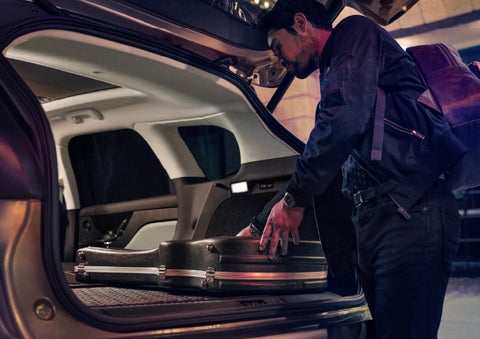 A man is shown loading cargo into the rear of a 2026 Lincoln Corsair® SUV with the second-row seats folded flat. | Griffin Lincoln in Tifton GA