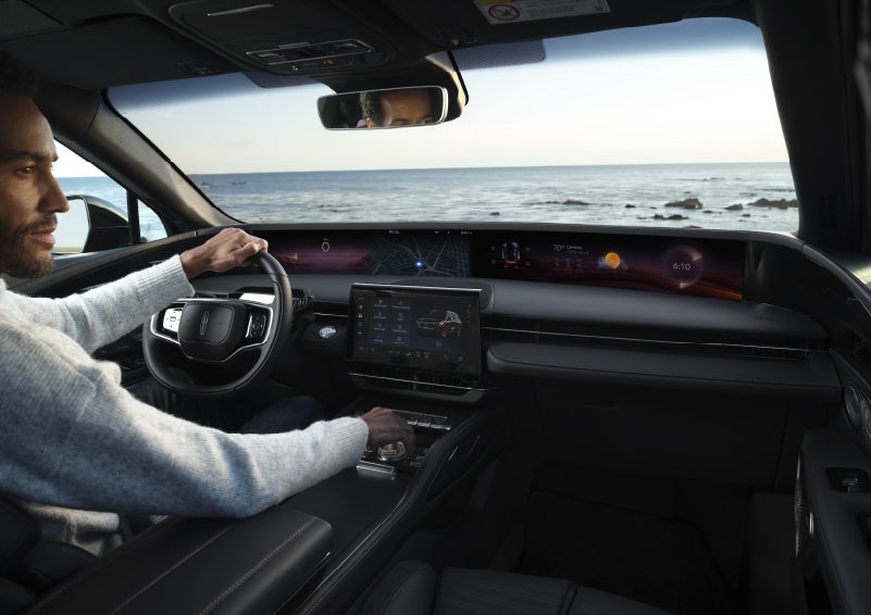 A driver of a parked 2026 Lincoln Nautilus® SUV takes a relaxing moment at a seaside overlook while inside his Nautilus. | Griffin Lincoln in Tifton GA
