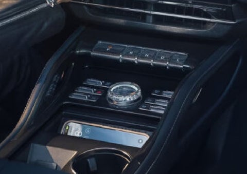 A smartphone is shown charging in the wireless charging pad. | Griffin Lincoln in Tifton GA