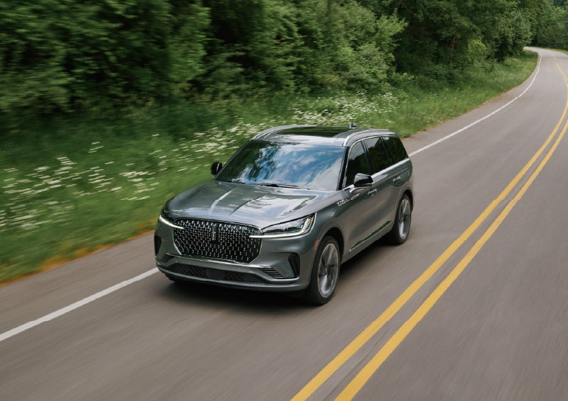A 2027 Lincoln Aviator® SUV is being driven down a road. | Griffin Lincoln in Tifton GA