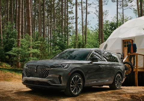 A 2027 Lincoln Aviator® is parked next to a high end glamping site. | Griffin Lincoln in Tifton GA