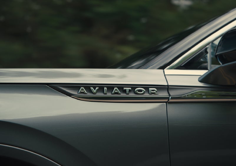 The driver’s side door and fender badging of a gray 2027 Lincoln Aviator® SUV are showcased. | Griffin Lincoln in Tifton GA