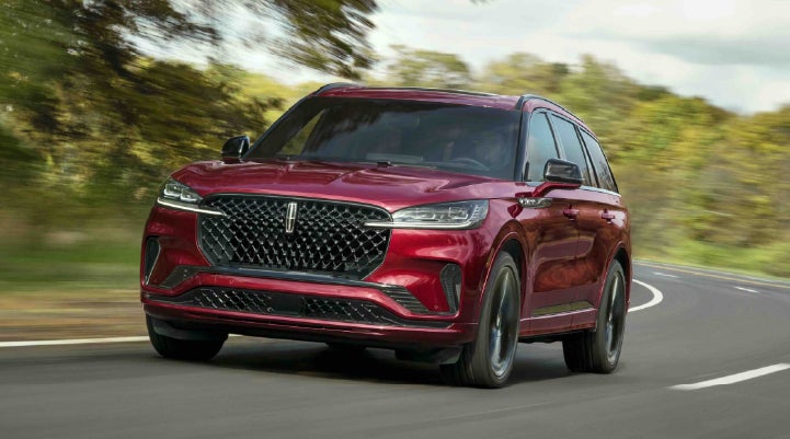 A 2027 Lincoln Aviator® SUV is being driven on a country road | Griffin Lincoln in Tifton GA