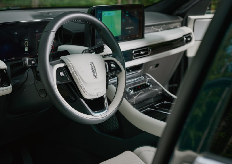 The leather-trimmed steering wheel of a 2027 Lincoln Aviator® Black Label™ SUV. | Griffin Lincoln in Tifton GA