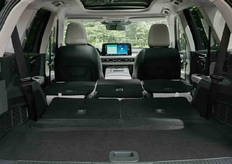 A rear to front view of the interior of a 2027 Lincoln Aviator® Black Label™ SUV shows the third and second rows folded flat | Griffin Lincoln in Tifton GA