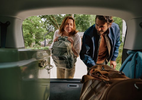 A couple loads luggage into the rear of a 2027 Lincoln Aviator® Black Label™ SUV..e 202 | Griffin Lincoln in Tifton GA