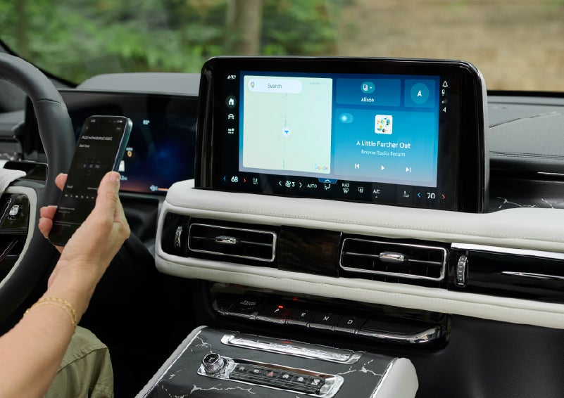 A person pairs thier phone with the center touchscreen of a 2027 Lincoln Aviator® Black Label™ SUV | Griffin Lincoln in Tifton GA